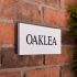 Granite House Sign 25.5 x 10cm 1 Line with sandblasted and painted background