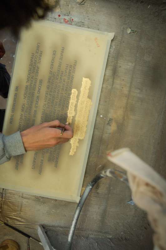 Gold paint applied to granite war memorial plaque